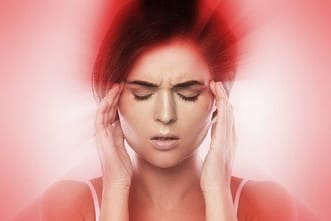 Research shows chiropractic relieves migraine pain a woman with her hand on her face
