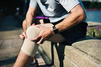 knee pain a man holding a white ball